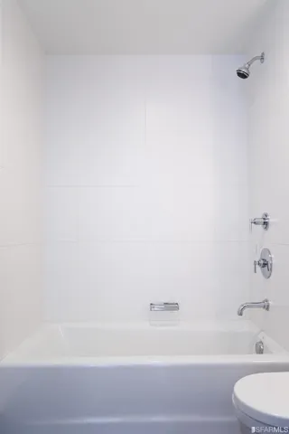 a bathroom with a bathtub and a toilet