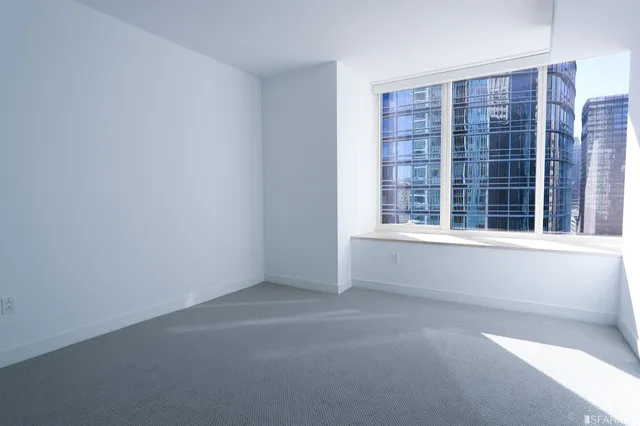 a view of an empty room with a window