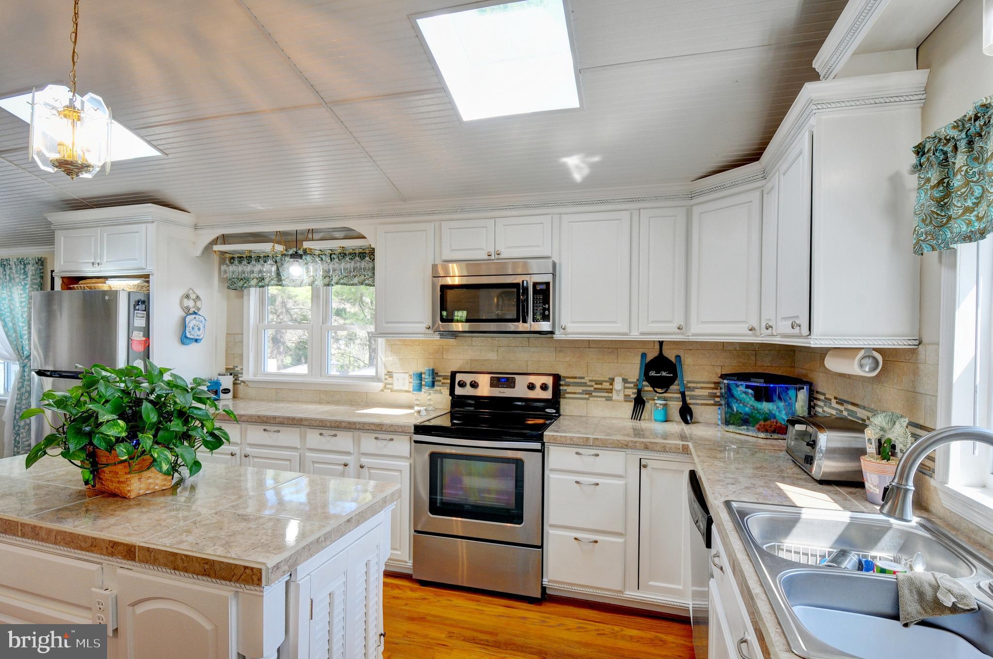 384 Perry Road Winchester, VA 22602 - Photo 11 of 61 a kitchen with granite countertop stainless steel appliances and white cabinets
