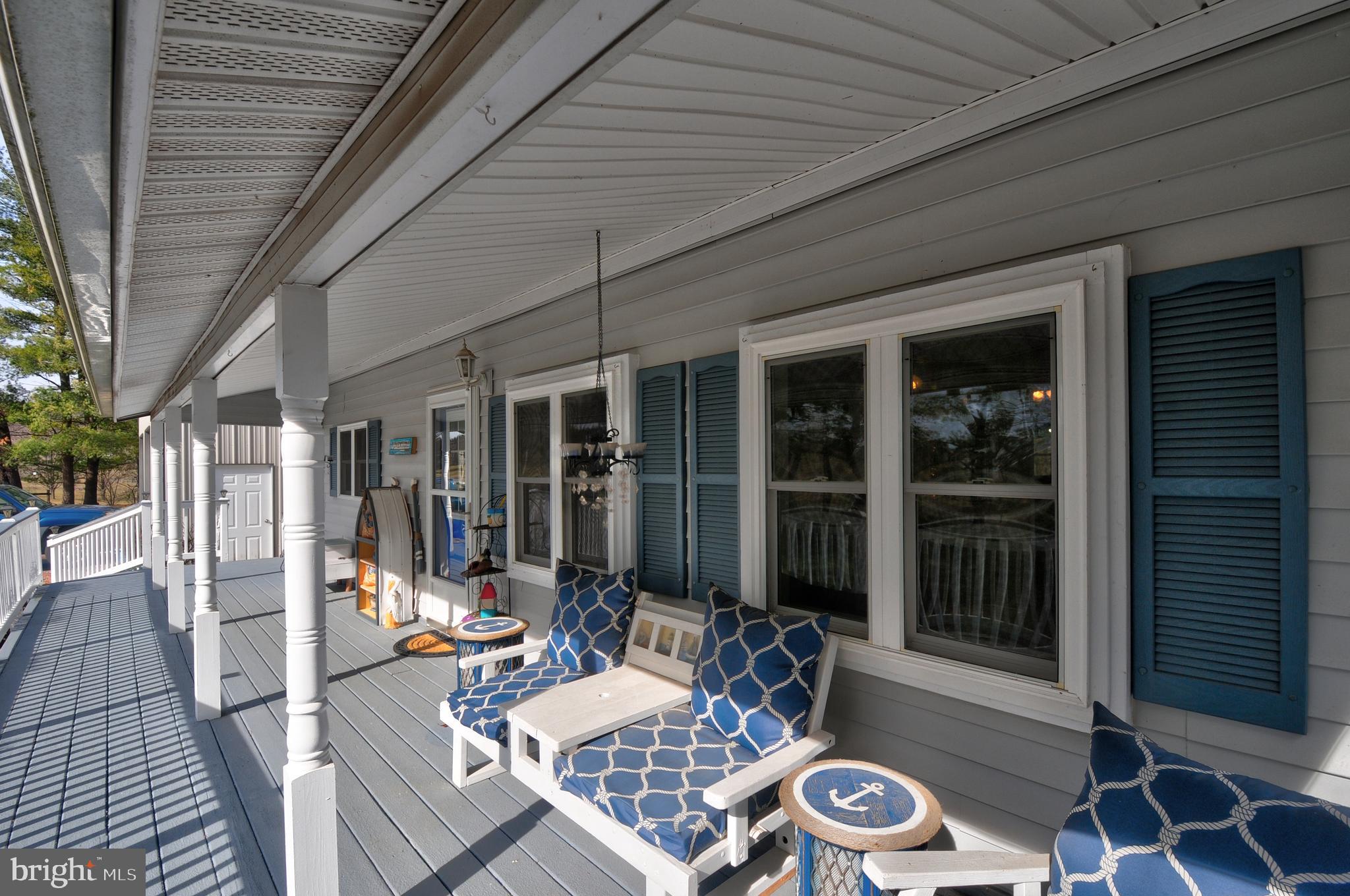 384 Perry Road Winchester, VA 22602 - Photo 4 of 61 a view of a patio with table and chairs and wooden floor