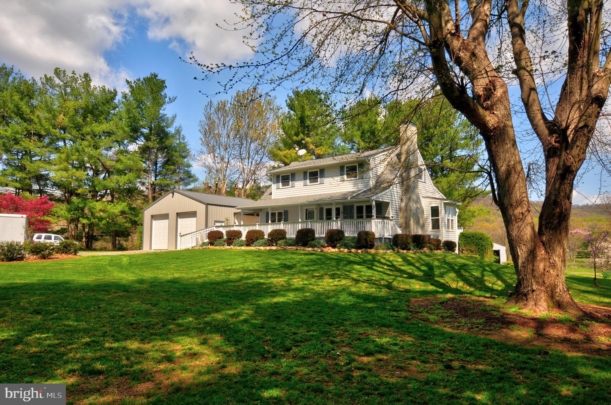384 Perry Road Winchester, VA 22602 - Photo 45 of 61 a view of a house with a big yard and large trees