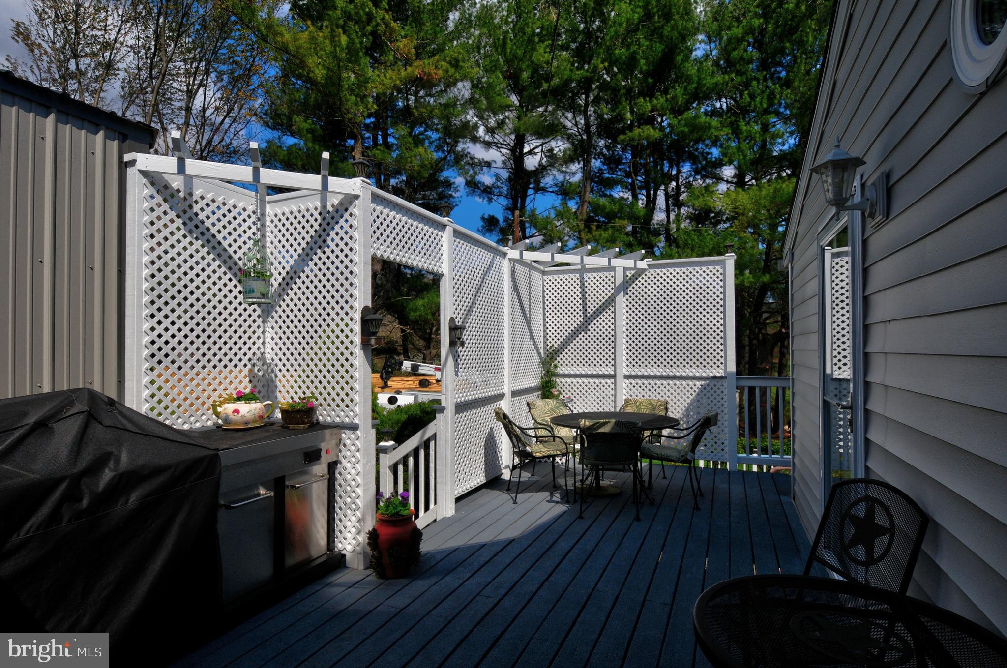 384 Perry Road Winchester, VA 22602 - Photo 48 of 61 a view of deck with table and chairs a barbeque with wooden floor and fence