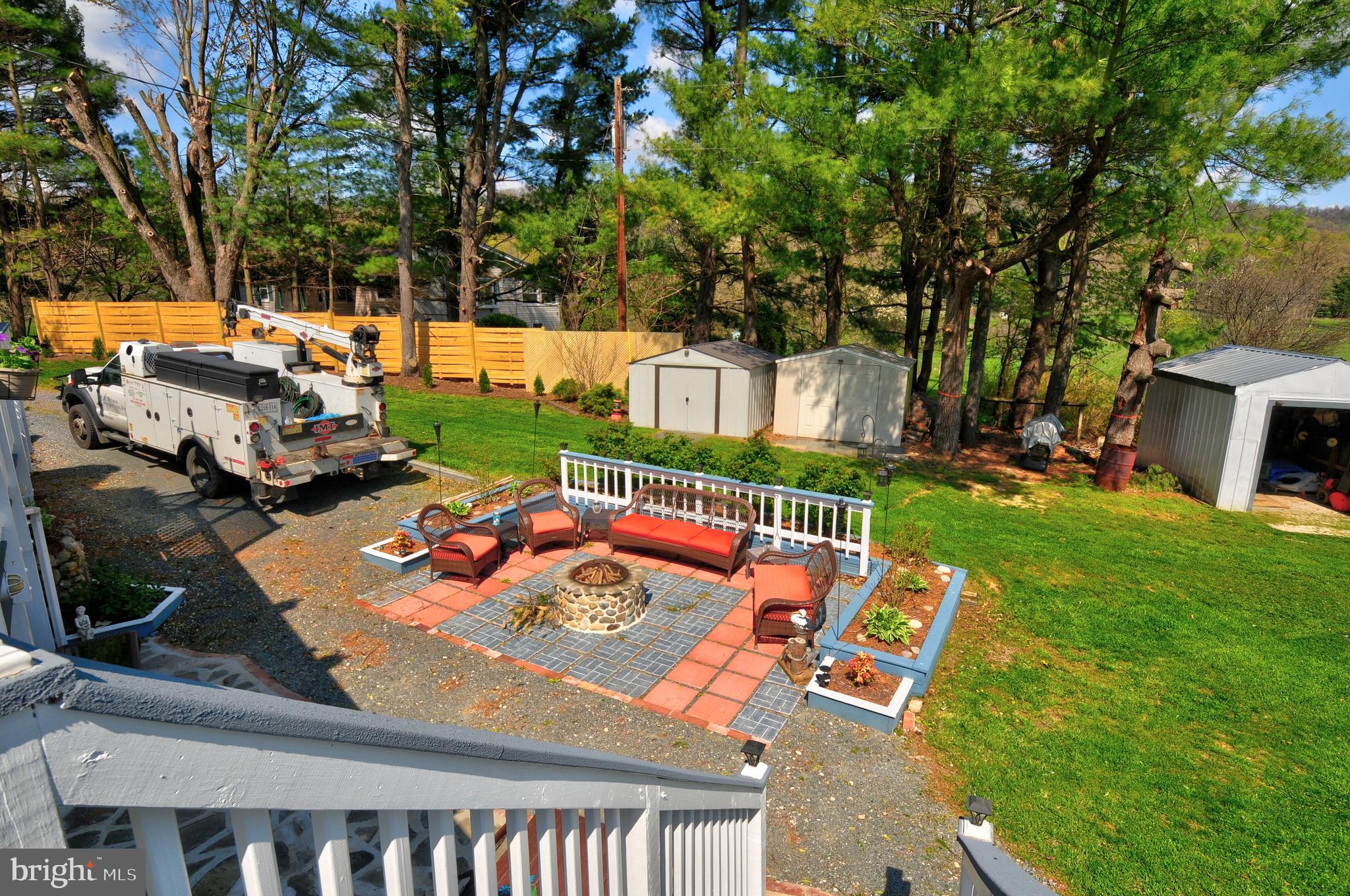 384 Perry Road Winchester, VA 22602 - Photo 51 of 61 a view of a patio with table and chairs potted plants and a large tree