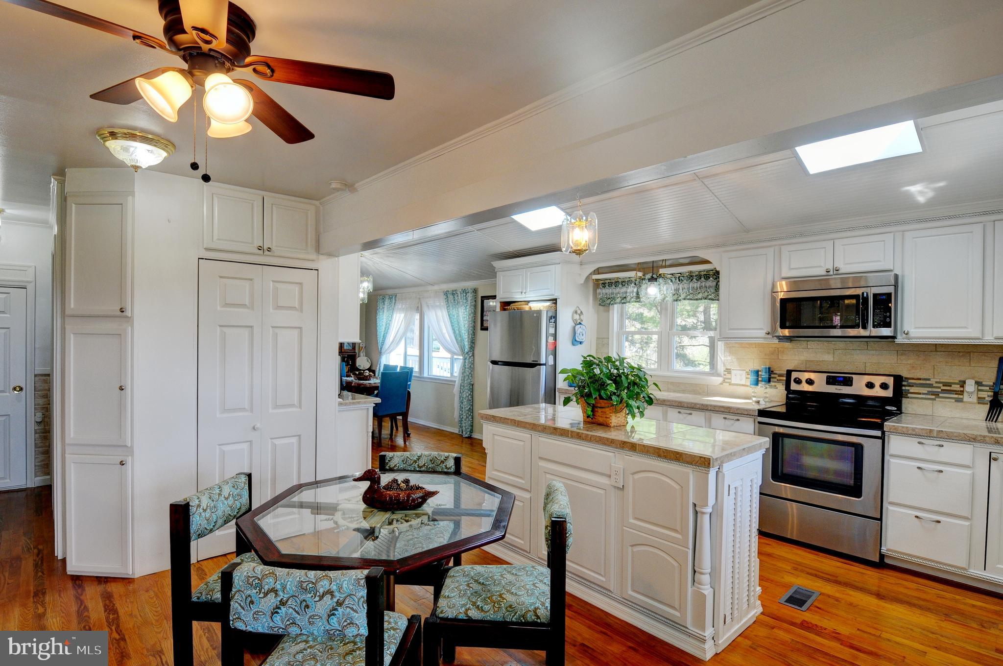 384 Perry Road Winchester, VA 22602 - Photo 10 of 61 a kitchen with stainless steel appliances kitchen island granite countertop a stove a sink and a refrigerator