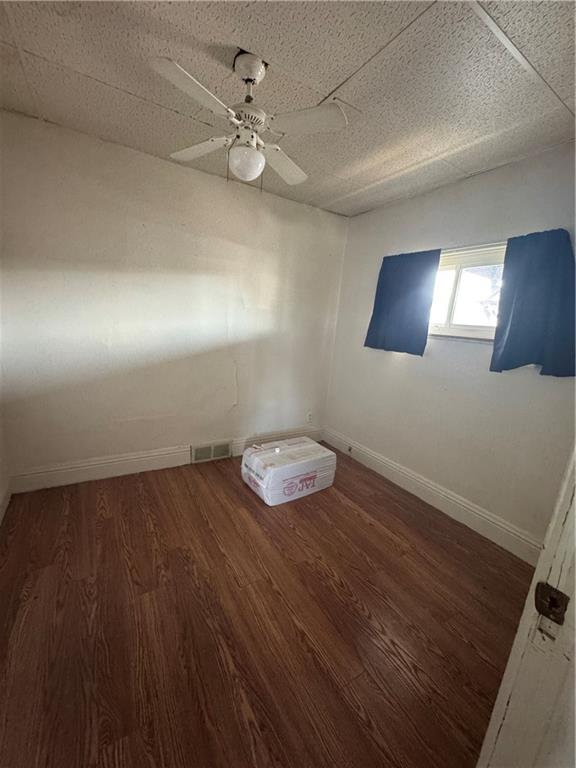 110 13th Street Conway, PA 15027 - Photo 3 of 6 wooden floor in an empty room with a window