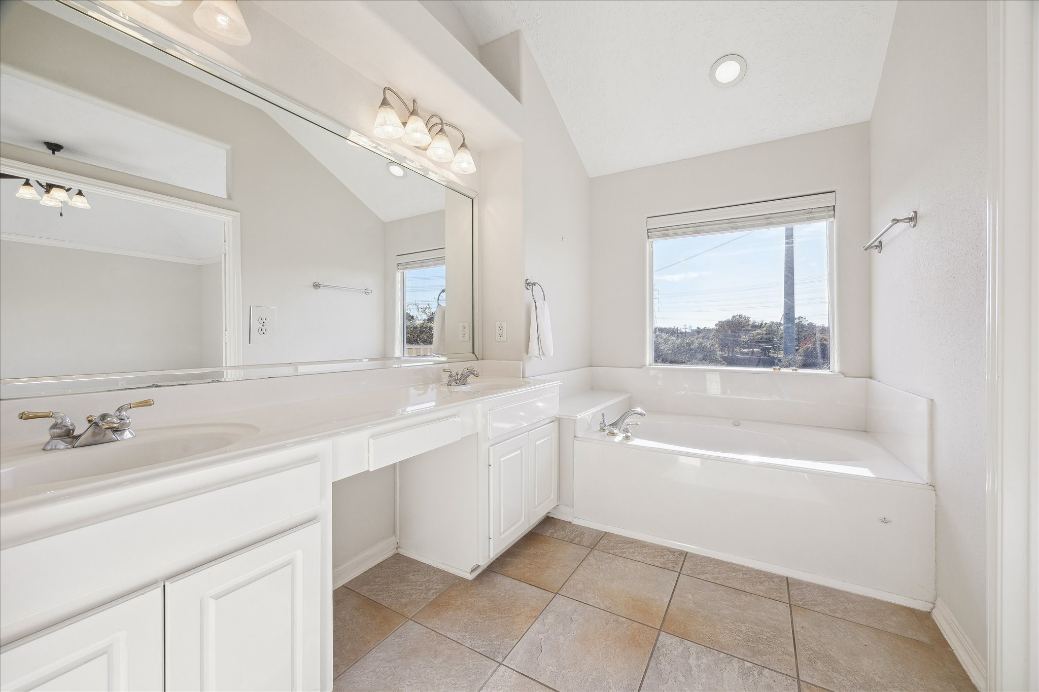 1839 Stacy Crest Houston, TX 77008 - Photo 20 of 39 a bathroom with a tub a sink double vanity and a mirror