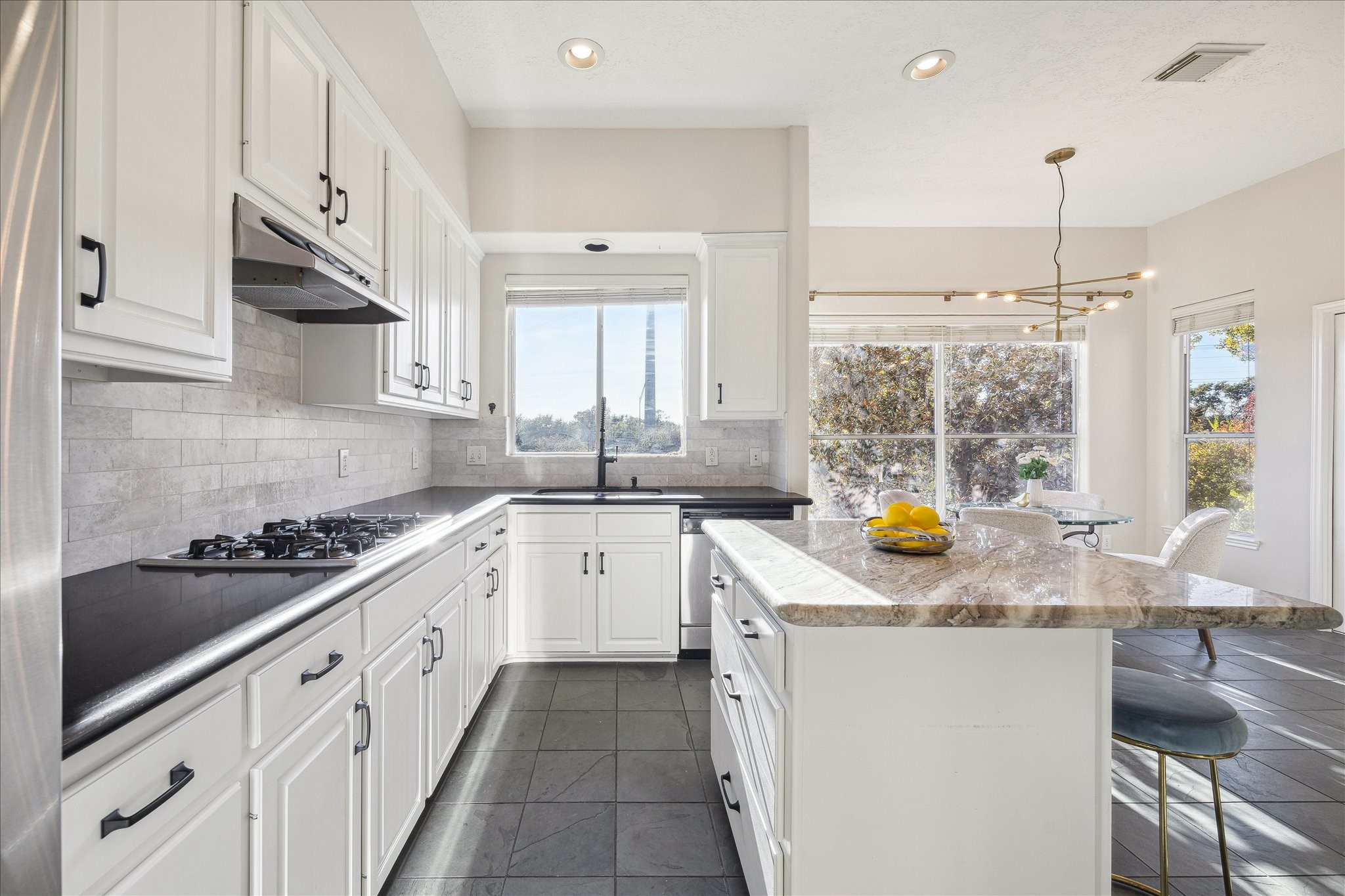 1839 Stacy Crest Houston, TX 77008 - Photo 5 of 39 a kitchen with stainless steel appliances granite countertop a sink stove and cabinets
