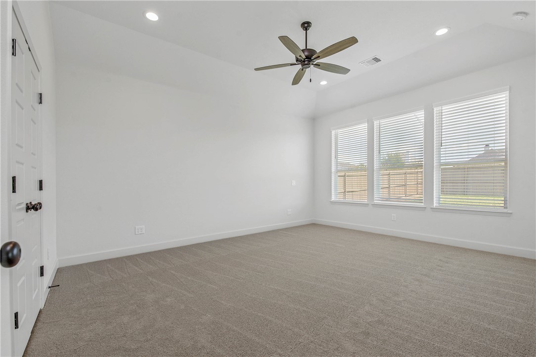 5010 Acadia Loop Bryan, TX 77802 - Photo 16 of 21 an empty room with ceiling fan and windows