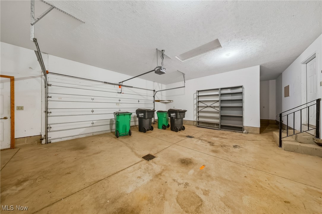 425 Overlook Drive Rittman, OH 44270 - Photo 21 of 44 Garage featuring baseboards and a garage door opener