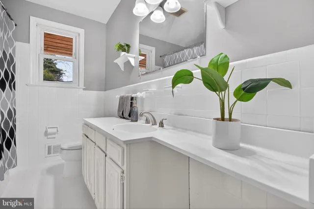 a bathroom with a sink a vanity and a mirror