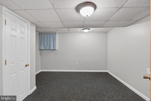 a view of empty room with wooden ceiling