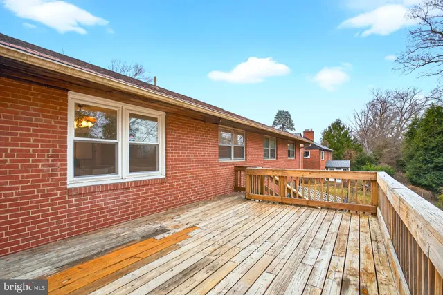 a front view of house with yard covered with large trees