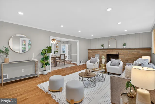 a living room with furniture a fireplace and a potted plant
