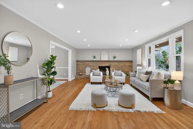 a living room with furniture kitchen view and large windows