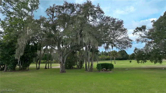 an aerial view of residential houses with outdoor space and lake view