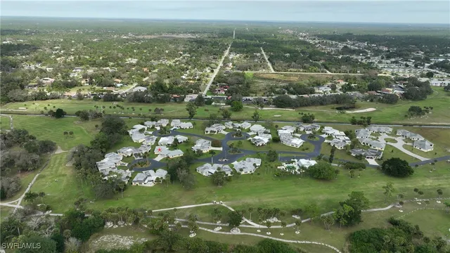 an aerial view of a house with swimming pool and garden