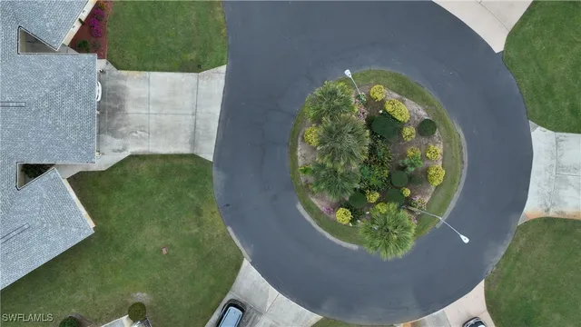 an aerial view of a house with swimming pool and garden