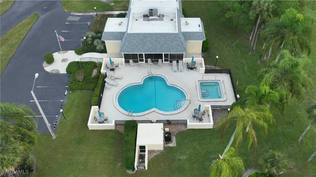 a aerial view of a house with a yard and potted plants