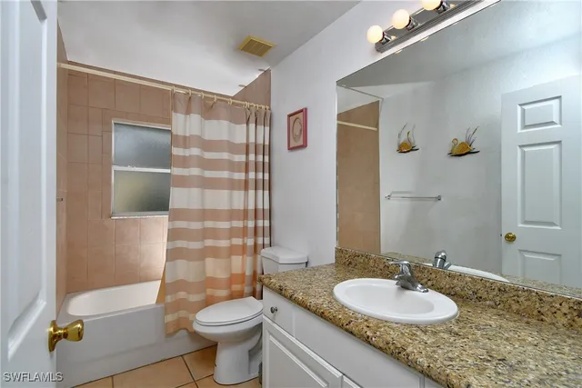 a bedroom with a bed and a lamp