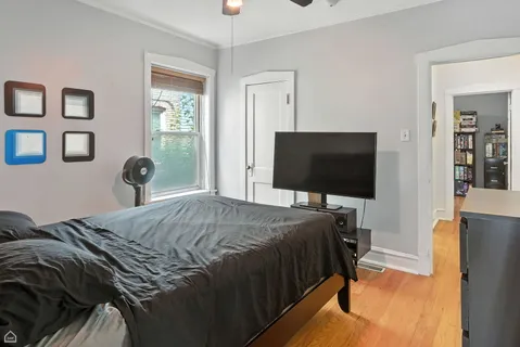 a bedroom with a bed and a chandelier