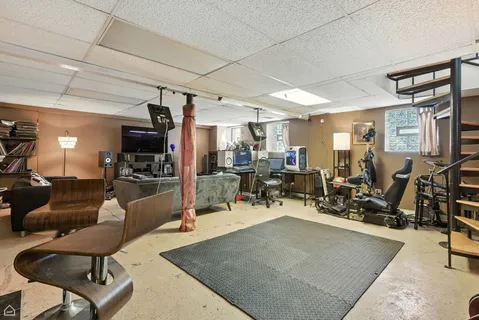 a front view of a building with table and chairs and potted plants