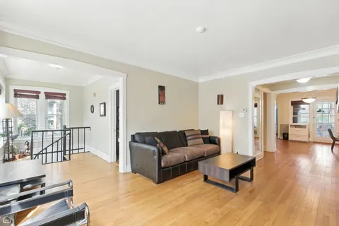 a living room with furniture and a table with wooden floor