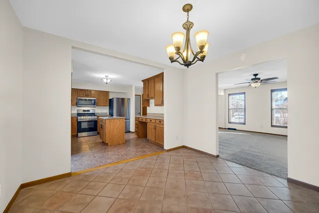 a view of a kitchen with a sink and chandelier