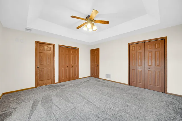 a view of empty room with ceiling fan