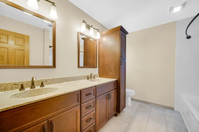 a bathroom with a double vanity sink mirror and double