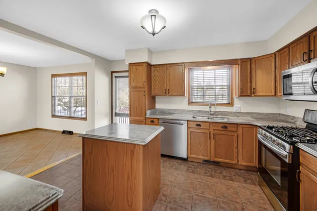 a kitchen with stainless steel appliances granite countertop a sink stove and cabinets