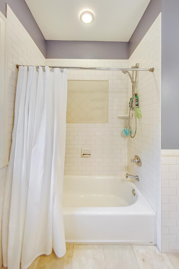 335 Ridge Road Kenilworth, IL 60043 - Photo 16 of 26 a bathroom with a shower and a bathtub