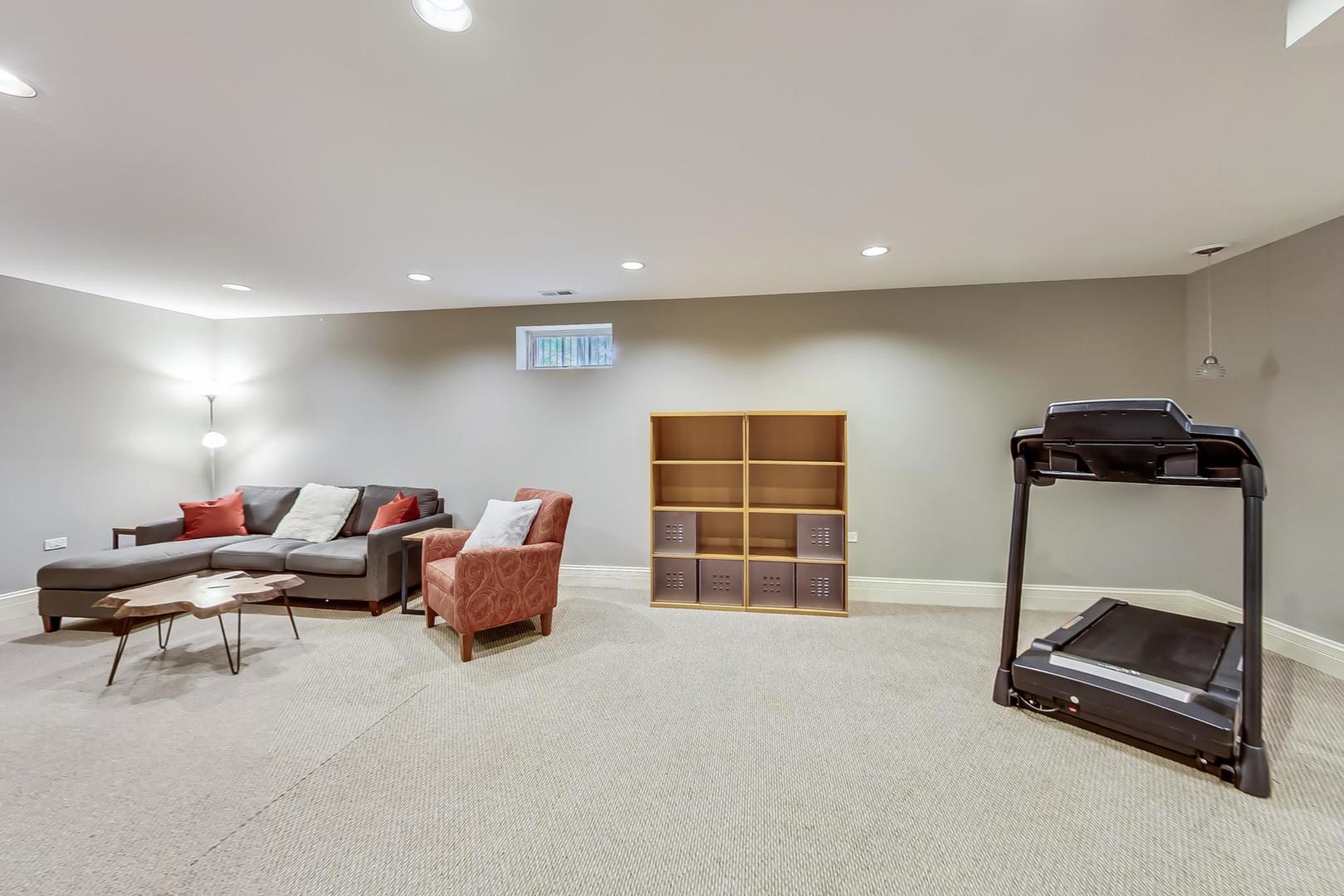 335 Ridge Road Kenilworth, IL 60043 - Photo 18 of 26 a living room with furniture gym equipment and a window