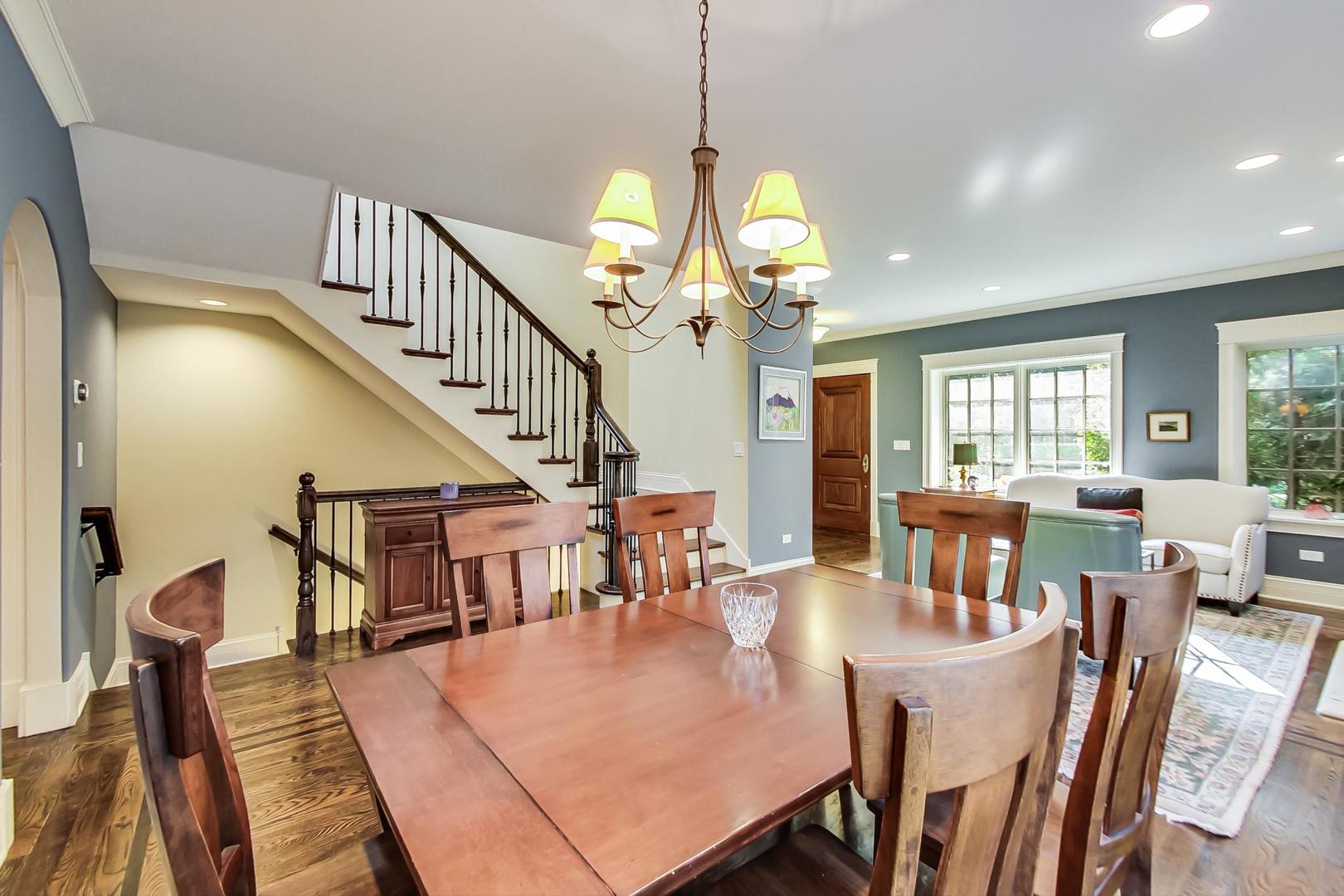 335 Ridge Road Kenilworth, IL 60043 - Photo 5 of 26 a view of a dining room and livingroom with furniture wooden floor a chandelier