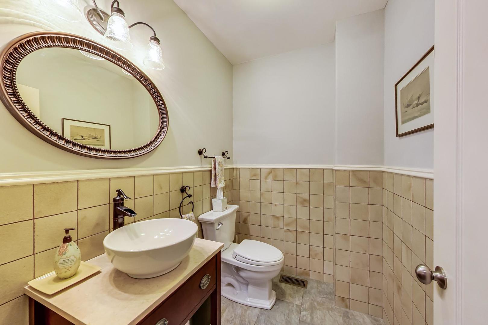 335 Ridge Road Kenilworth, IL 60043 - Photo 9 of 26 a bathroom with a toilet a sink and a mirror