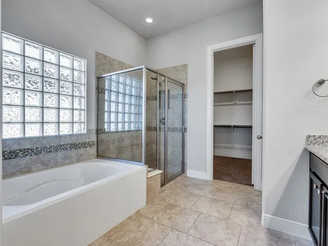 a spacious bathroom with a bathtub and a shower