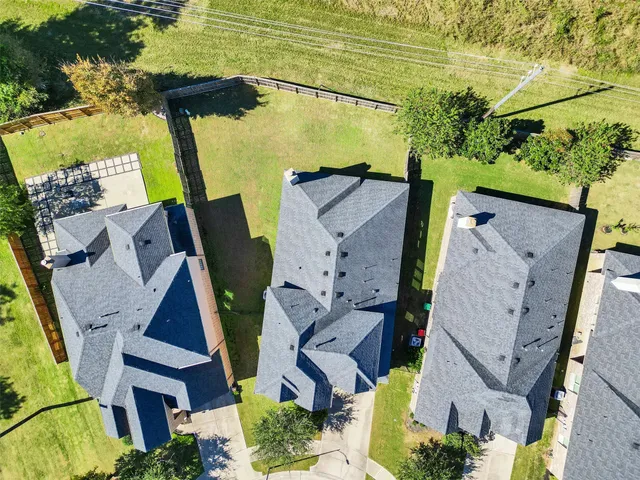 an aerial view of residential houses with outdoor space and swimming pool