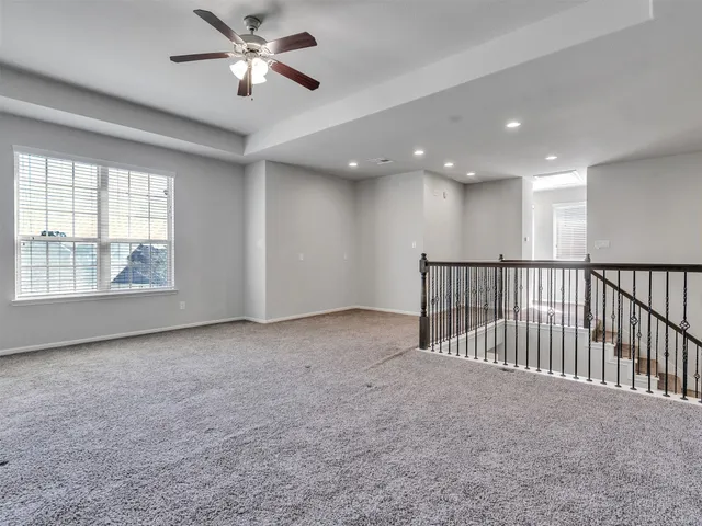 a view of a livingroom with a ceiling fan and window