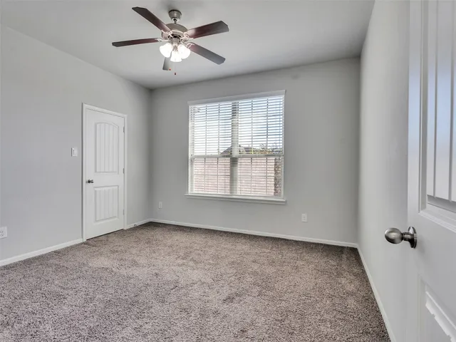 a bedroom with a bed and a chandelier fan