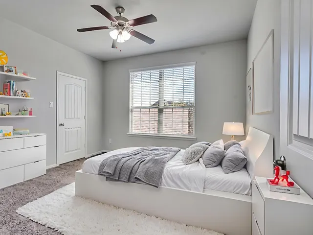 a bathroom with a granite countertop sink a toilet and shower