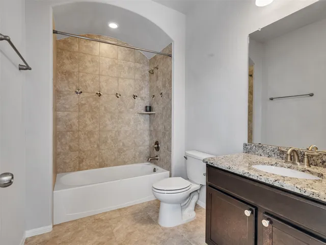 a view of yard from deck with patio