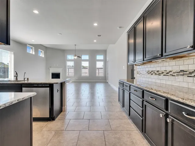 a view of a kitchen with stainless steel appliances granite countertop a stove and a sink