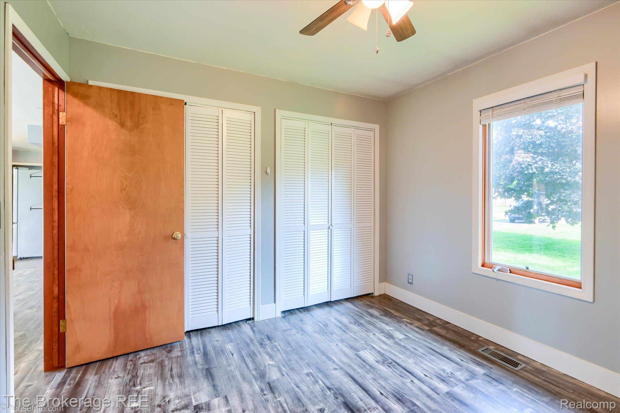 5495 East Coldwater Road Flint, MI 48506 - Photo 26 of 44 Room featuring wood-finish flooring, light grey wall paint, and white trim