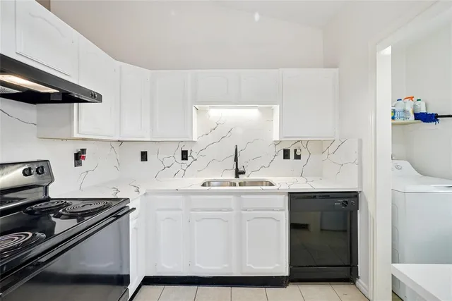 a kitchen with stainless steel appliances a sink and cabinets