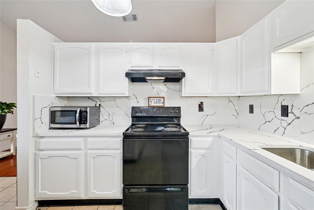 4522 Ebb Tide Drive Rowlett, TX 75088 - Photo 12 of 26 a kitchen with cabinets appliances a sink and a counter