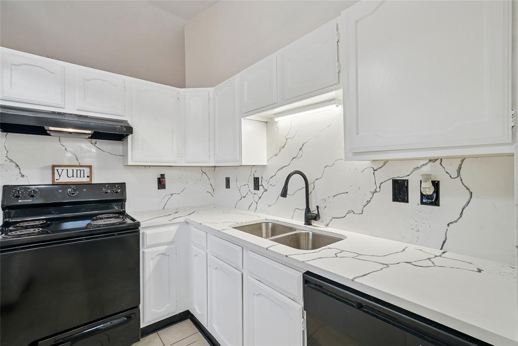 4522 Ebb Tide Drive Rowlett, TX 75088 - Photo 13 of 26 a kitchen with a sink cabinets and appliances
