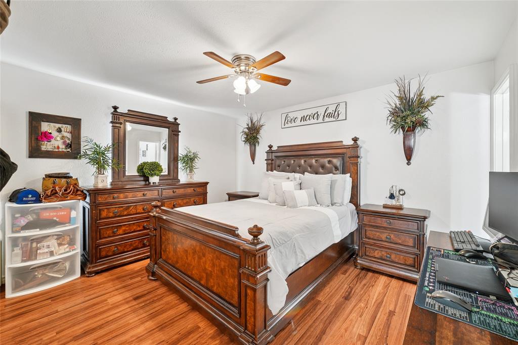 4522 Ebb Tide Drive Rowlett, TX 75088 - Photo 14 of 26 a bed room with a bed and a chandelier