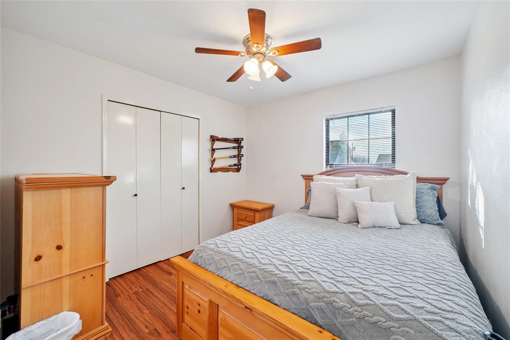 4522 Ebb Tide Drive Rowlett, TX 75088 - Photo 17 of 26 a bedroom with a large bed and a chandelier