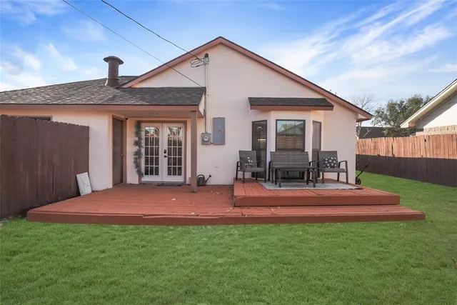 a backyard of a house with yard table and chairs
