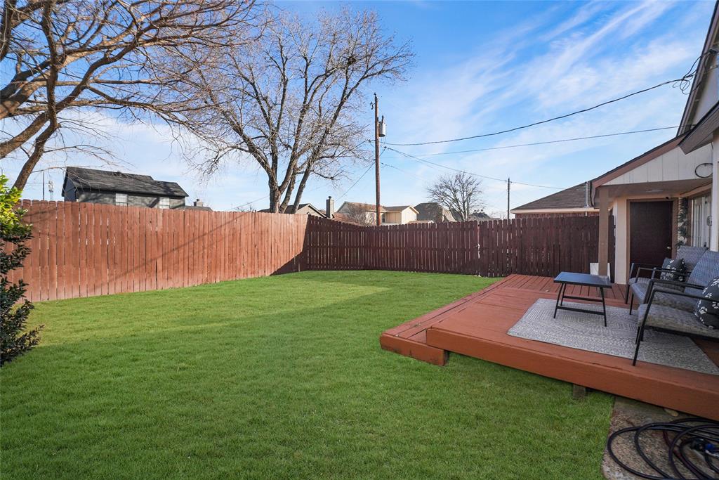 4522 Ebb Tide Drive Rowlett, TX 75088 - Photo 22 of 26 a view of a backyard with table and chairs with wooden fence