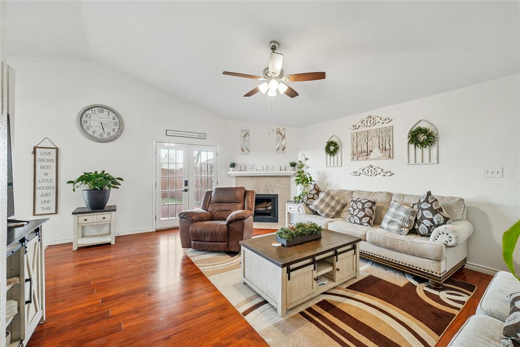 4522 Ebb Tide Drive Rowlett, TX 75088 - Photo 5 of 26 a living room with furniture a clock and a fireplace